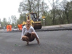 Girl does a strip show for a crew of road workers